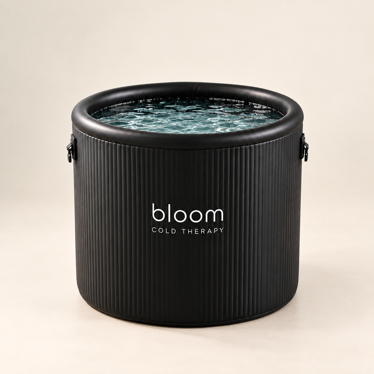 Bloom Ice Pro Tub with black ribbed walls and water, photographed against a soft warm ivory studio backdrop.