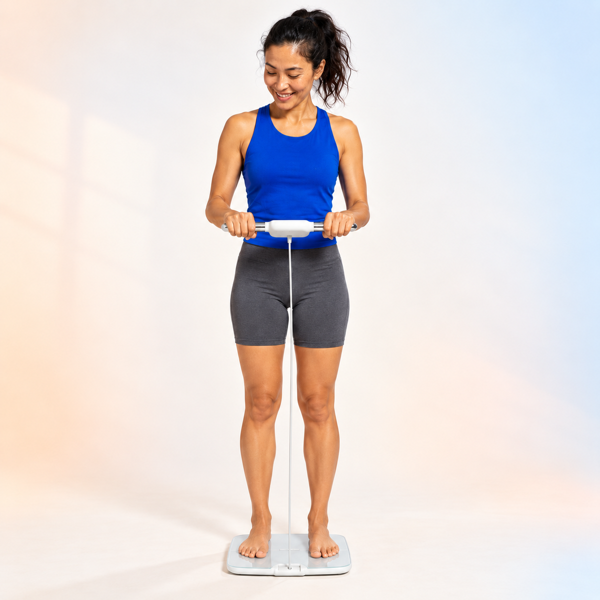 Full-body studio portrait of a woman using the Bloom Body Smart Scale against a soft powder-blue and peach background